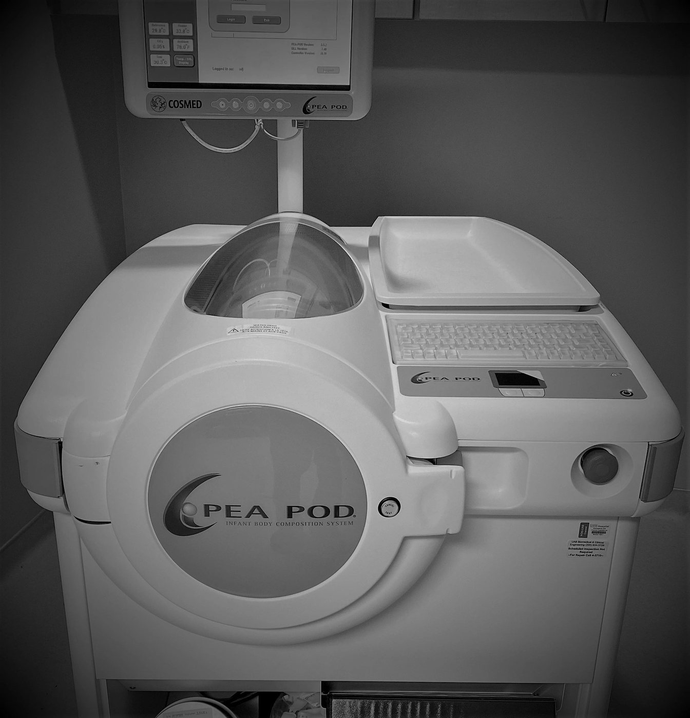 Medical device labeled PEA POD for infant body composition analysis.